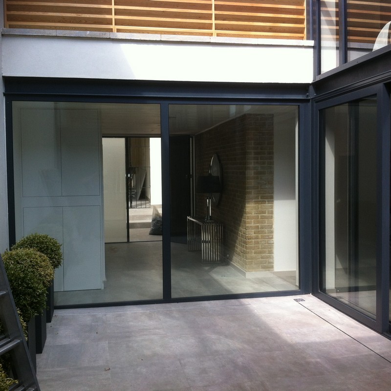Floor-to-ceiling sliding doors opening to courtyard in Sutton