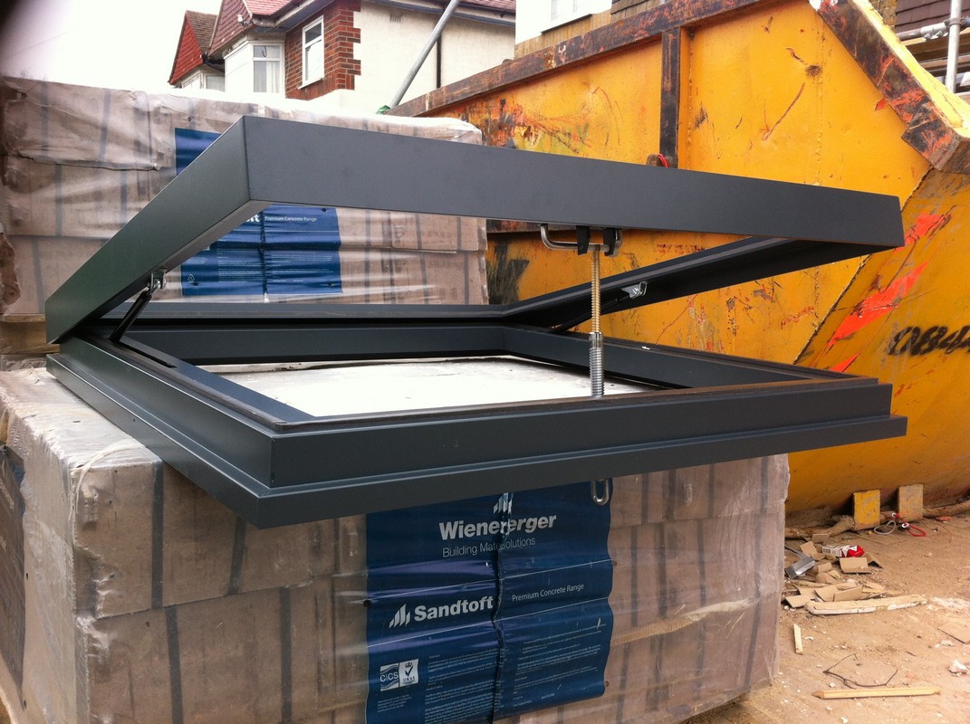 Opening flat roof skylight in anthracite grey installed in Sutton
